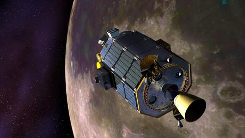 An artist's concept of NASA's Lunar Atmosphere and Dust Environment Explorer (LADEE) spacecraft orbiting the moon and preparing to fire its maneuvering thrusters to maintain a safe orbital altitude.